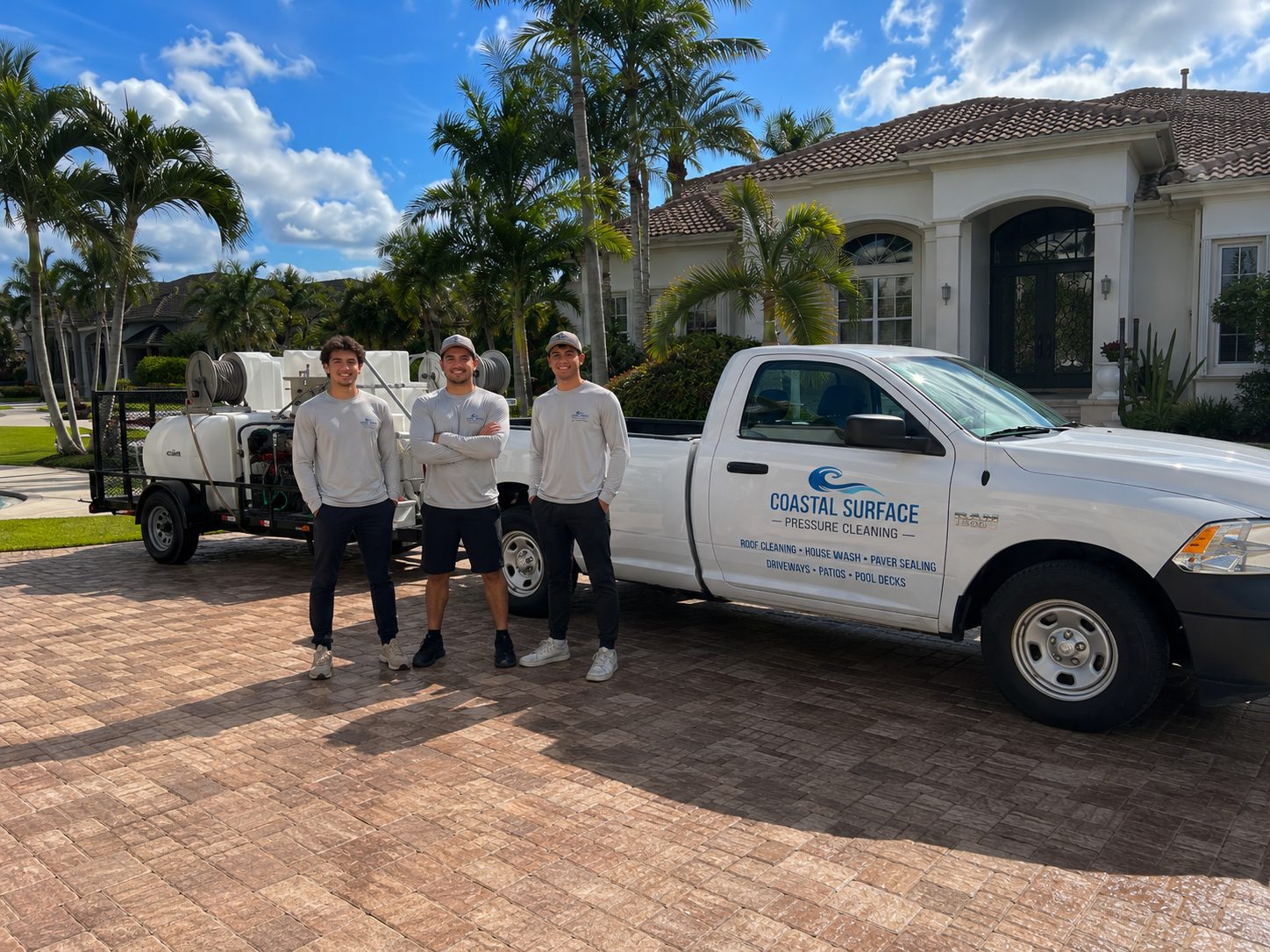 The Coastal Surface Pressure Cleaning team in front of their branded truck and equipment